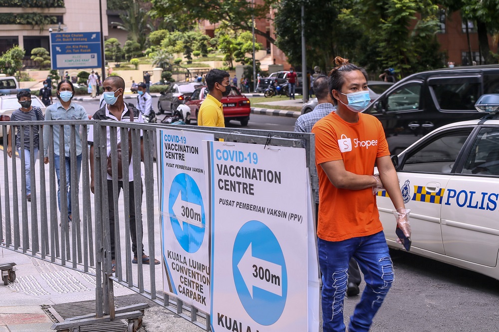 Foreign workers are seen at the KLCC vaccination centre to receive their Covid-19 vaccine July 27, 2021. u00e2u20acu201d Picture by Ahmad Zamzahuri