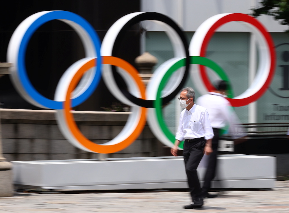 A man wearing a protective mask, amid the coronavirus disease (Covid-19) outbreak, walks past an Olympic Ring installation in Tokyo, Japan, July 28, 2021. u00e2u20acu201d Reuters pic