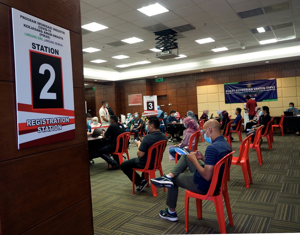 People are seen practising social distancing as they wait to receive their Covid-19 vaccination in Melaka July 12, 2021. u00e2u20acu201d Bernama pic