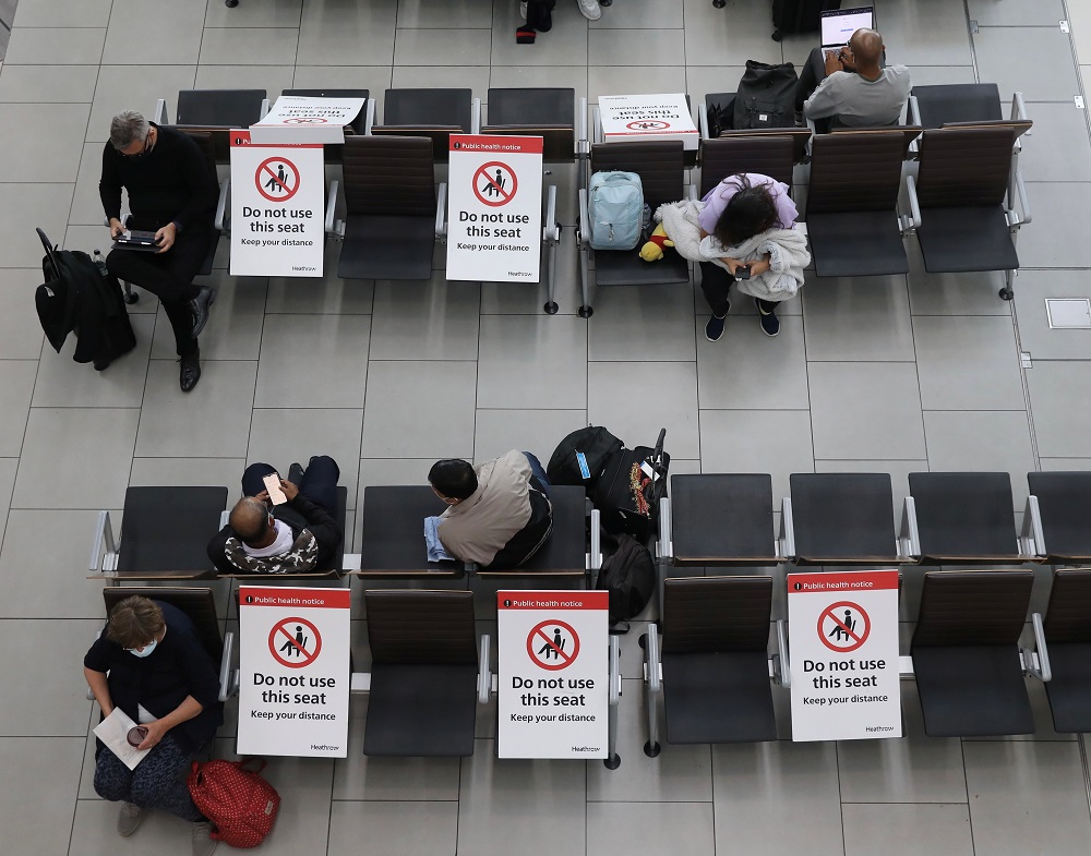 Passengers wait on socially distanced chairs at Heathrow Airport amid the Covid-19 pandemic in London July 7, 2021. u00e2u20acu2022 Reuters pic