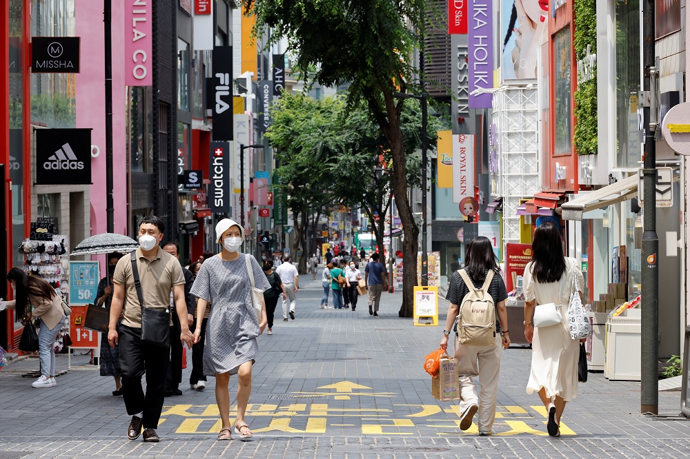People wearing masks walk in a shopping district amid the Covid-19 pandemic in Seoul July 9, 2021. u00e2u20acu2022 Reuters pic