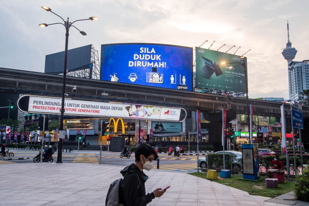 An LED screen bearing a message reminding Malaysians to stay home is seen at Bukit Bintang, Kuala Lumpur July 13, 2021. u00e2u20acu201d Picture by Firdaus Latif