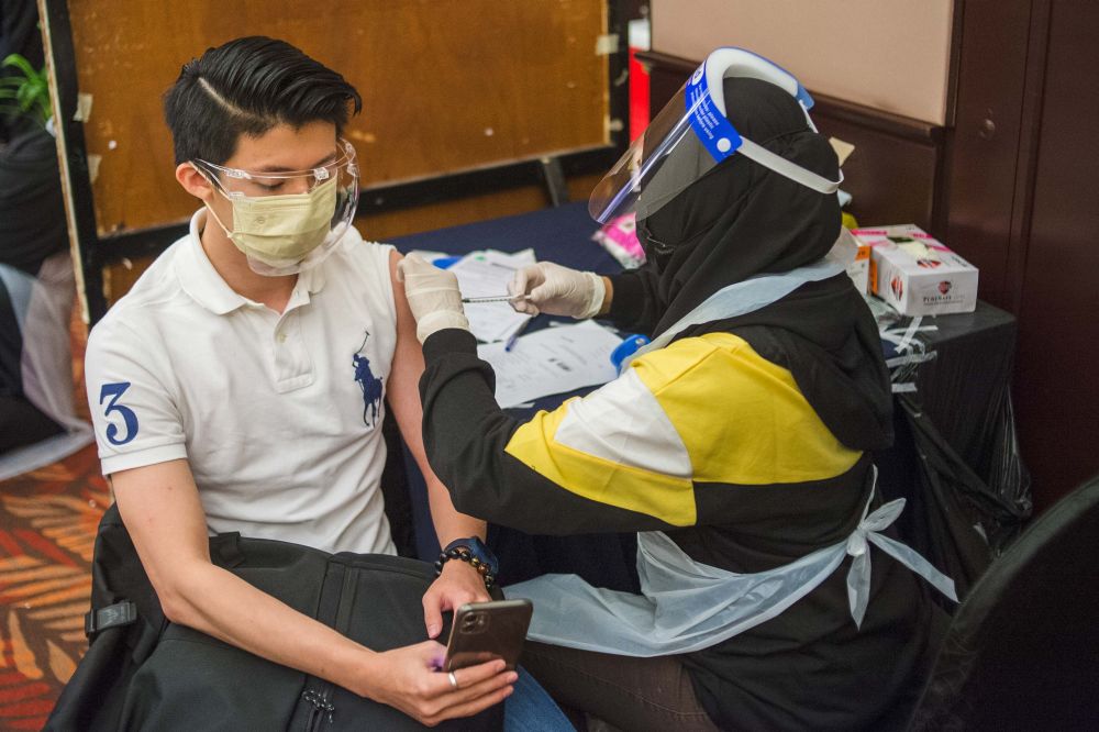 People receive their Covid-19 jabs at the Eastin Hotel in Petaling Jaya July 23, 2021. u00e2u20acu201d Picture by Shafwan Zaidon