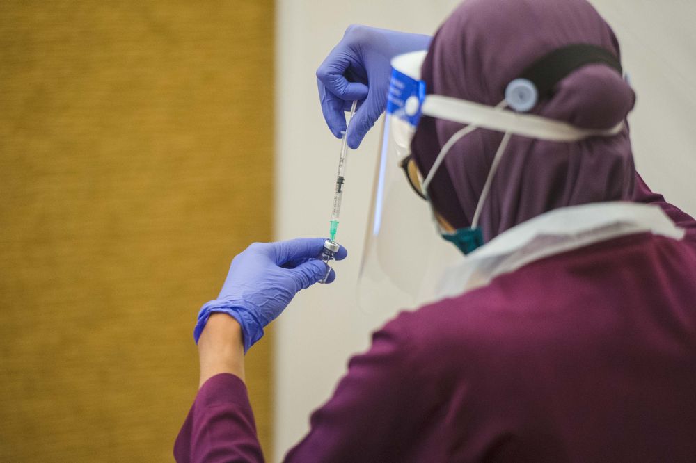 A health worker prepares a dose of the Covid-19 vaccine at the Eastin Hotel, Petaling Jaya July 23, 2021. u00e2u20acu201d Picture by Shafwan Zaidon