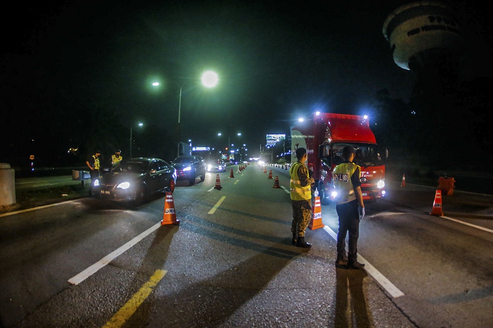Police and army personnel man a roadblock at KM34 of the Federal Highway in Kuala Lumpur June 2, 2021. u00e2u20acu2022 Picture by Hari Anggara