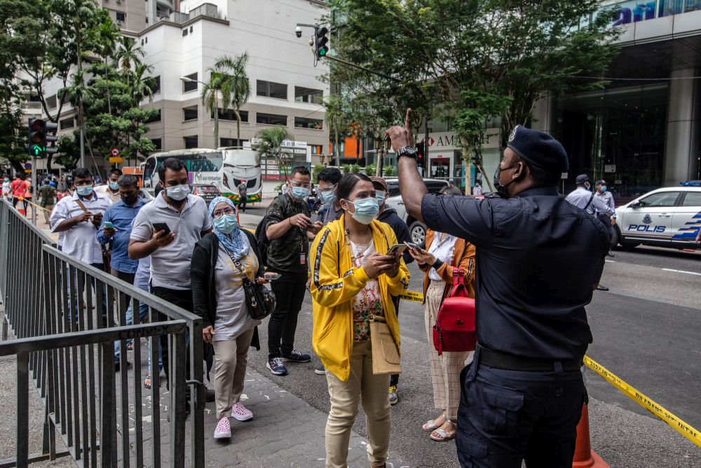 Foreign workers are pictured at the KLCC vaccination centre to receive their Covid-19 jab July 29, 2021. u00e2u20acu201d Picture by Firdaus Latif