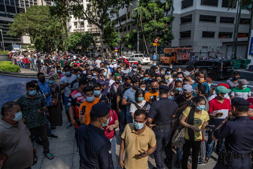 Foreign workers are seen at the KLCC vaccination centre to receive their Covid-19 jab July 28, 2021. u00e2u20acu201d Picture by Firdaus Latif