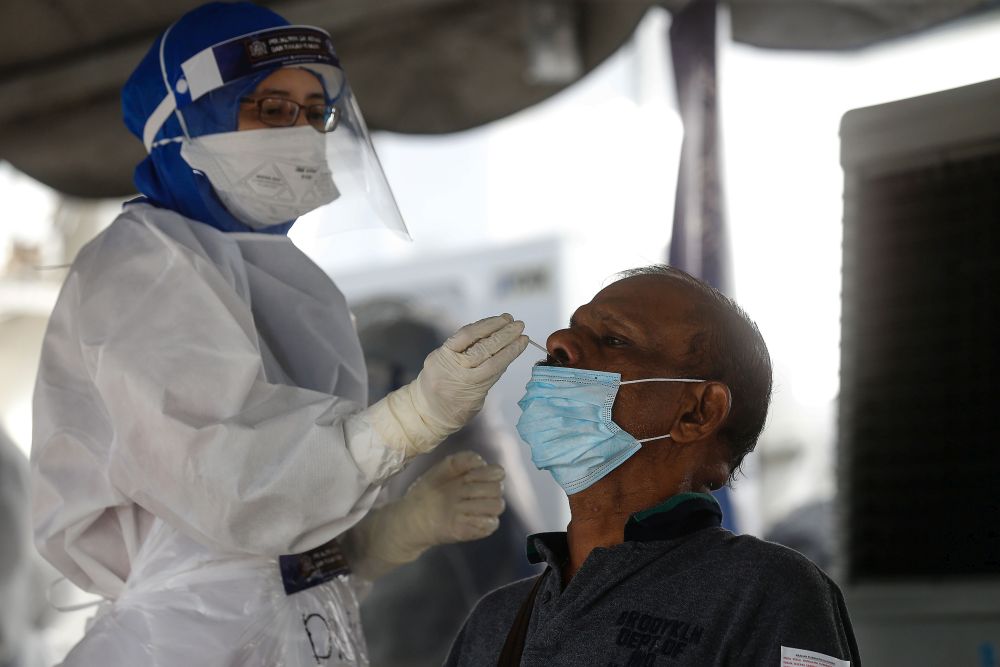 Healthcare workers collect swab samples to test for Covid-19 at the City Stadium in George Town July 5, 2021. u00e2u20acu201d Picture by Sayuti Zainudin