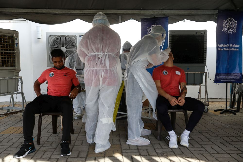 Healthcare workers collect swab samples to test for Covid-19 at the City Stadium in George Town July 5, 2021. u00e2u20acu201d Picture by Sayuti Zainudin