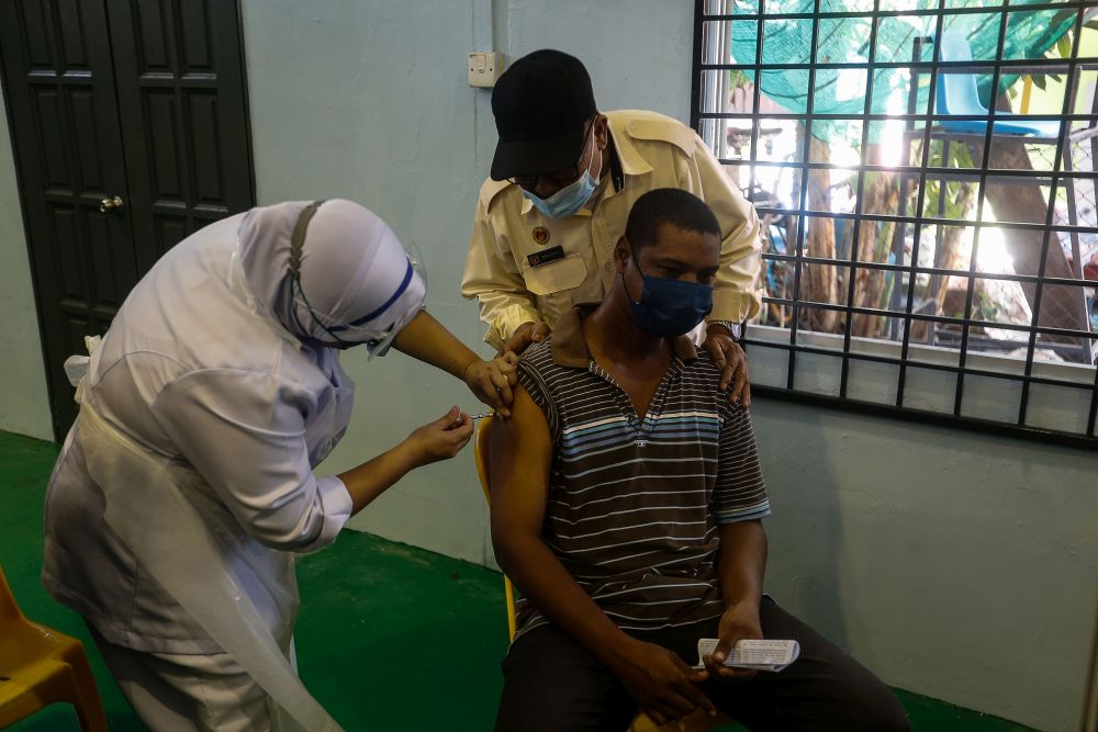 Pulau Aman residents receive their Covid-19 jabs as part of the south Seberang Perai health district's mobile outreach programme in Pulau Aman July 8, 2021. u00e2u20acu201d Picture by Sayuti Zainudin
