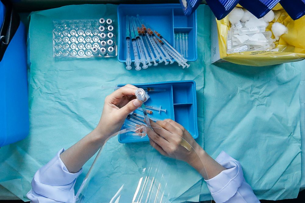 A nurse loads a syringe with a dose of the Covid-19 vaccine at a mobile vaccination centre stationed at Sekolah Kebangsaan Pai Chai, Batu Feringghi July 28, 2021. u00e2u20acu201d Picture by Sayuti Zainudin