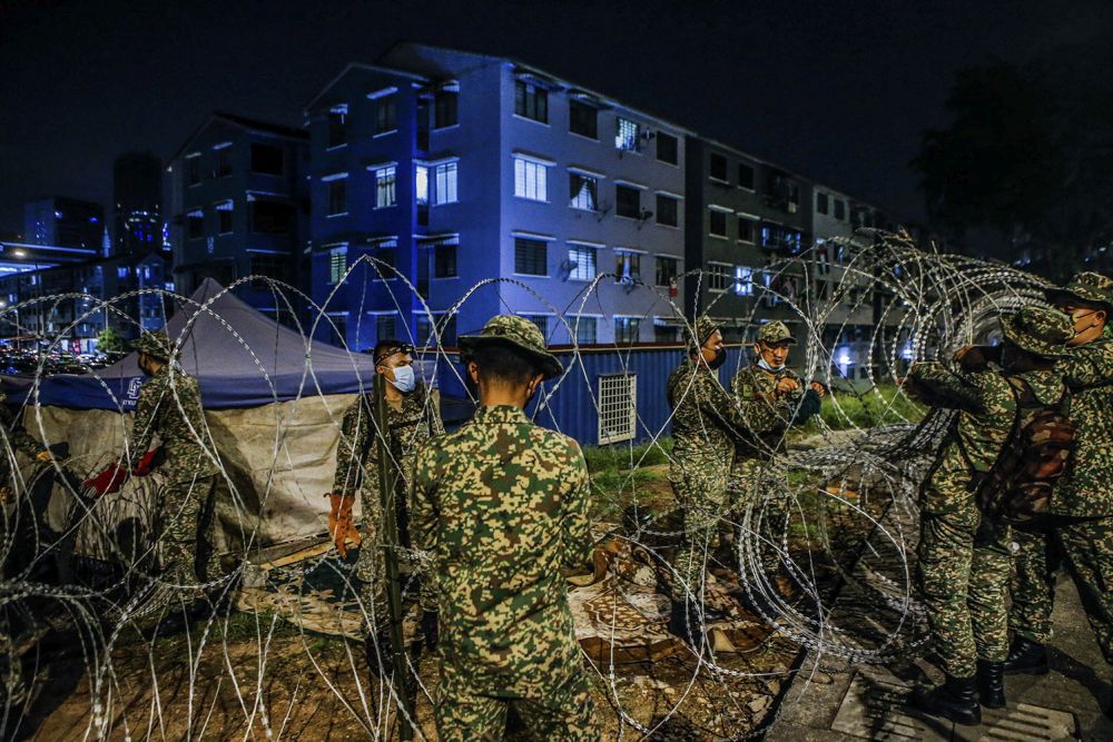 Armed Forces personnel erect barbed wire fencing around the Taman Bukit Angkasa flat buildings in Kuala Lumpur June 30, 2021. u00e2u20acu2022 Picture by Hari Anggarann