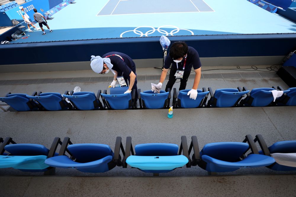 Olympics personnel clean seats at the Ariake Tennis Park, Tokyo July 23, 2021. u00e2u20acu201d Reuters pic