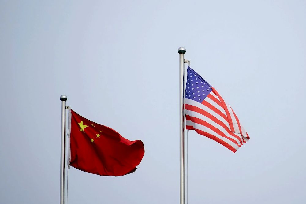 Chinese and US flags flutter outside a company building in Shanghai, China April 14, 2021. u00e2u20acu201d Reuters file pic