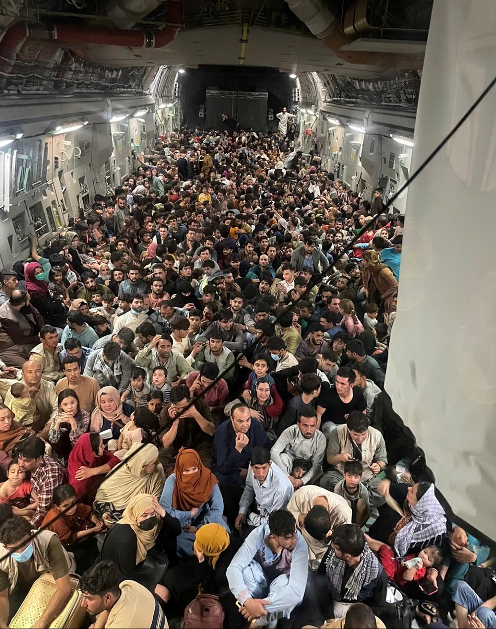 Evacuees crowd the interior of a US Air Force C-17 Globemaster III transport aircraft, carrying some 640 Afghans to Qatar from Kabul August 15, 2021. u00e2u20acu201d Picture courtesy of Defence One/Handout via Reuters  