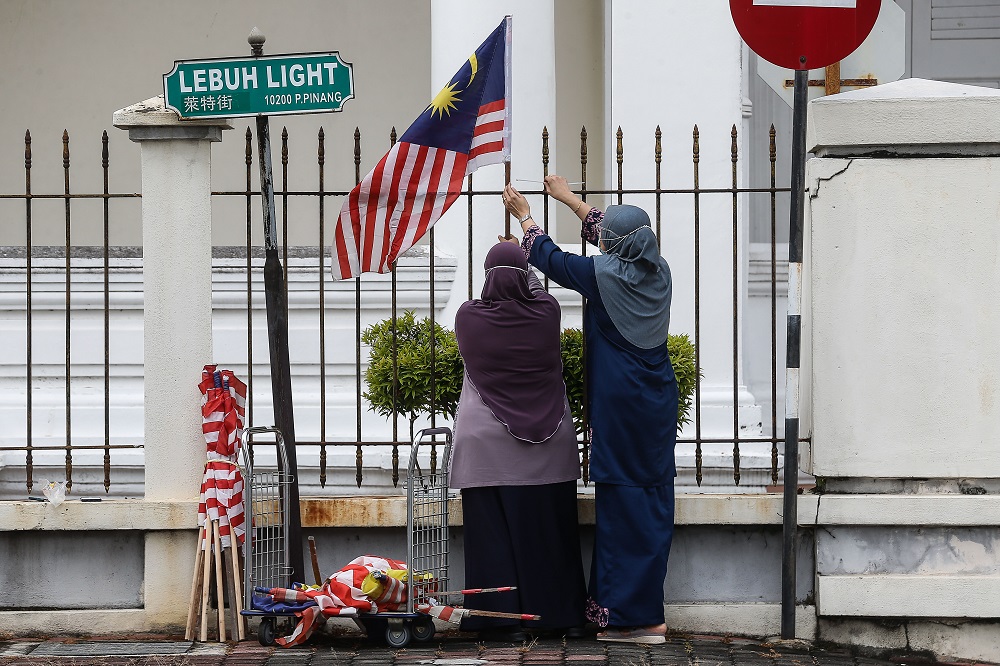 Staff decorate the Penang Court Complex compound with the Jalur Gemilang ahead of the Merdeka Day celebrations, in George Town August 2, 2021. u00e2u20acu201d Picture by Sayuti Zainudin