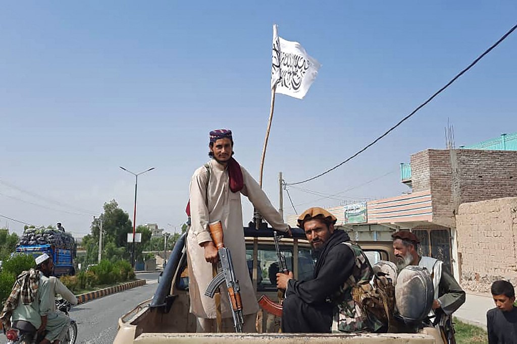 Taliban fighters drive an Afghan National Army (ANA) vehicle through the streets of Laghman province on August 15, 2021. u00e2u20acu201d AFP picn n