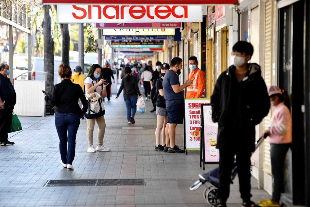 Residents wear face masks waiting for their take-away food orders in the suburb of Cabramatta in Sydney August 17, 2021. u00e2u20acu201d AFP pic