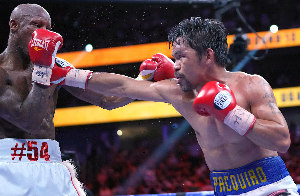 Manny Pacquiao (right) fights Yordenis Ugas in a world welterweight championship bout at T-Mobile Arena, Las Vegas August 21, 2021. u00e2u20acu201d Stephen R. Sylvanie-USA TODAY Sports
