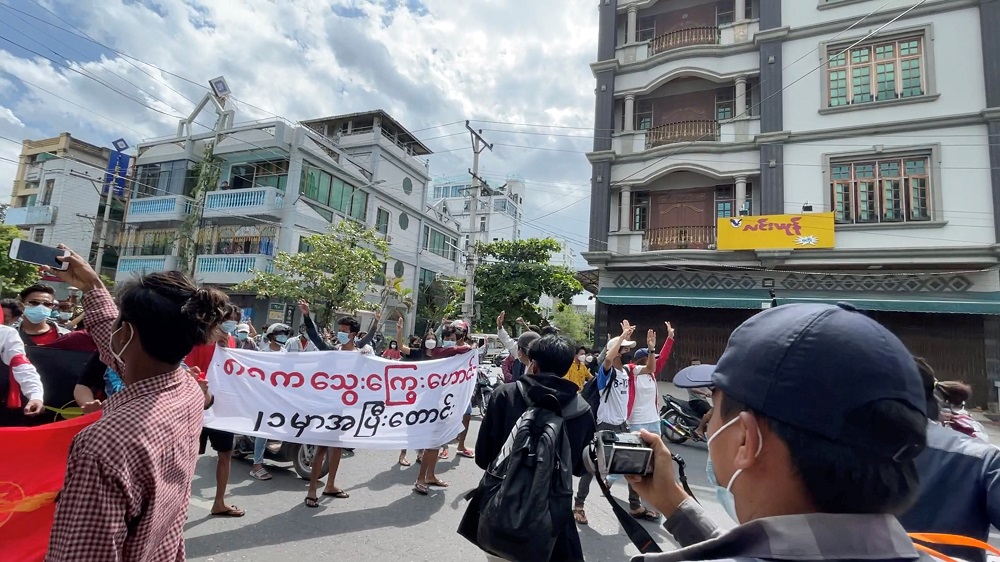 Anti-coup protesters display a banner during a march on the anniversary of a 1988 uprising, in Mandalay, Myanmar August 8, 2021 in this still image obtained by Reuters from a social media video. u00e2u20acu2022 Handout via Reuters