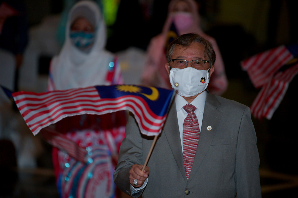 Sarawak Chief Minister Datuk Patinggi Abang Johari Openg waves the Jalur Gemilang at the launch of the National Month celebration in Kuching, August 16, 2021. u00e2u20acu201d Bernama pic 