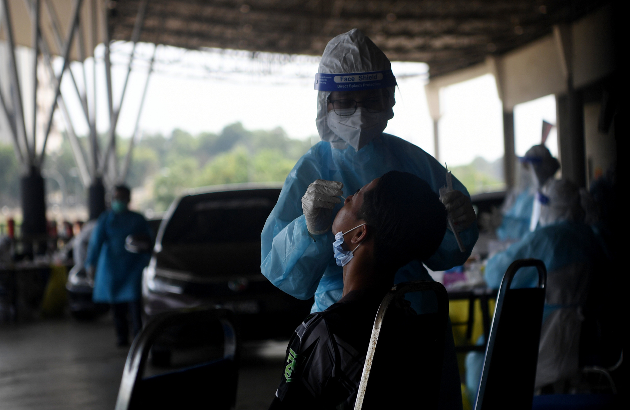 A health worker conducts a Covid-19 swab test. u00e2u20acu201d Bernama pic