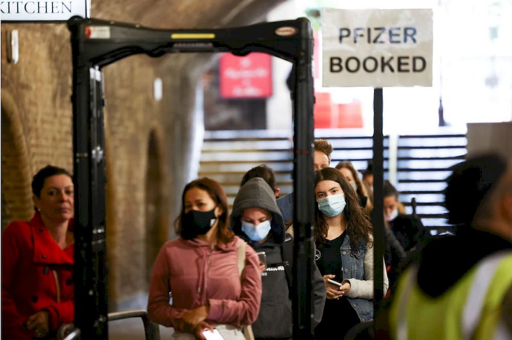 People queue to receive a dose of the Pfizer BioNTech vaccine at an NHS vaccination centre hosted at the Heaven nightclub, amid the coronavirus disease (Covid-19) pandemic, in London, August 8, 2021. u00e2u20acu201d Reuters pic