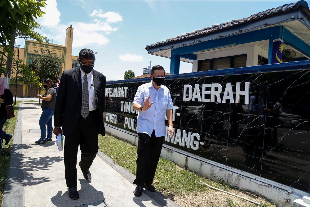 Bagan MP Lim Guan Eng is seen with Jelutong MP RSN Rayer at the Northeast district police station in George Town August 11, 2021. u00e2u20acu2022 Picture by Sayuti Zainudin