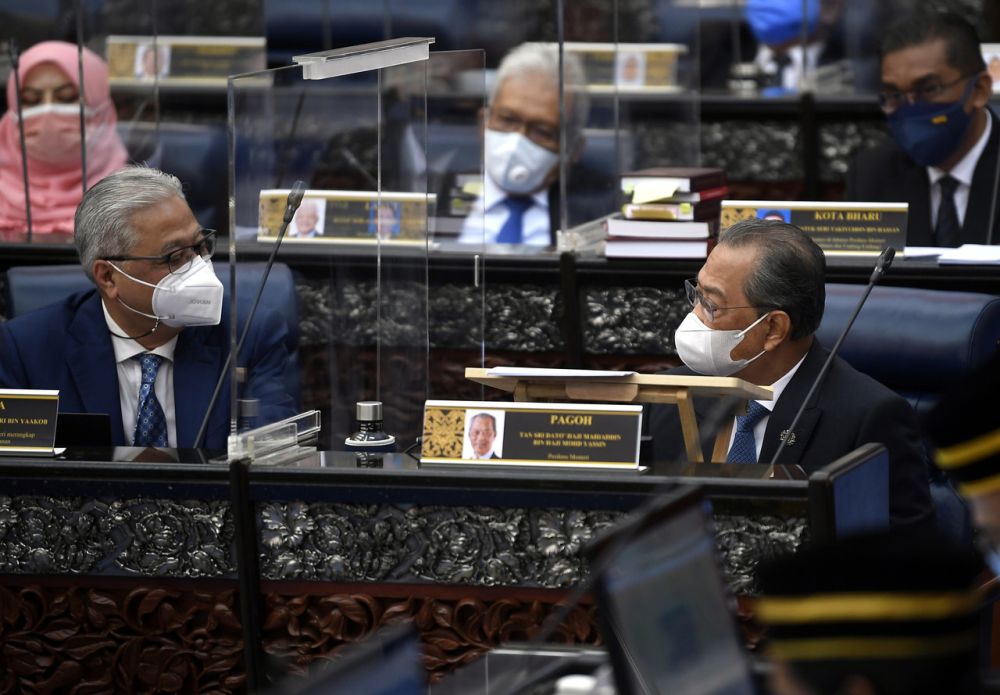 Prime Minister Tan Sri Muhyiddin Yassin is seen talking to Deputy Prime Minister Datuk Seri Ismail Sabri Yaakob during a special Parliament sitting in Kuala Lumpur July 26, 2021. u00e2u20acu201d Bernama pic