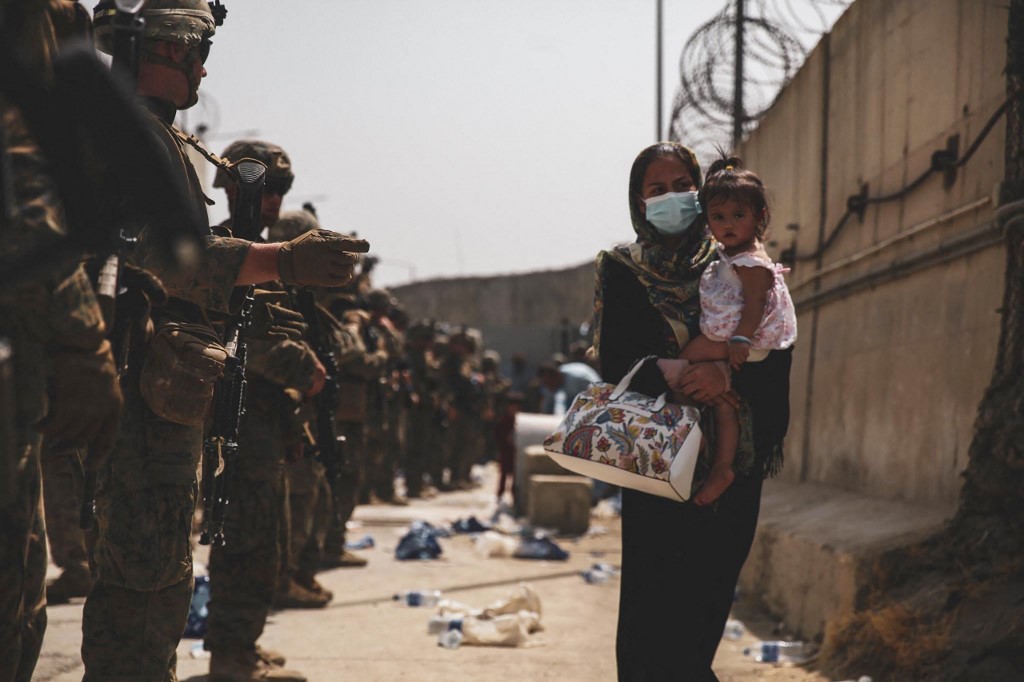 This handout photo courtesy of US Marines Corps shows Marines with the 24th Expeditionary Unit (MEU) guide an evacuee during an evacuation at Hamid Karzai International Airport, Kabul, Afghanistan, August 18, 2021. u00e2u20acu201d US MARINE CORPS/AFP pic