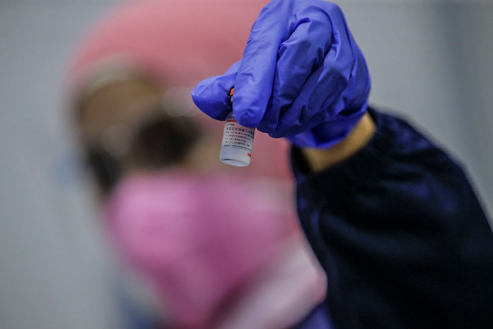 A health personnel show a vial of Covid-19 vaccine at the Kuala Lumpur Convention Centre vaccination centre, August 2, 2021. u00e2u20acu2022 Picture by Hari Anggara
