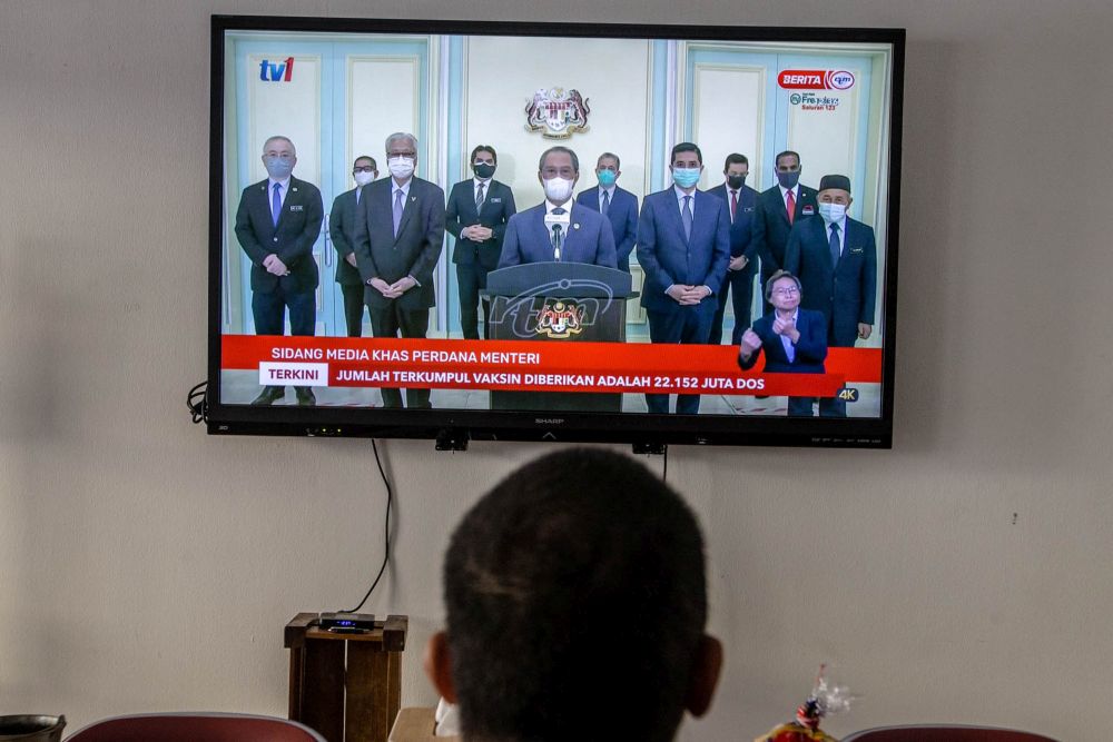 A man watches a live telecast of Prime Minister Tan Sri Muhyiddin Yassin's speech in Kuala Lumpur August 4, 2021. u00e2u20acu201d Picture by Firdaus Latif