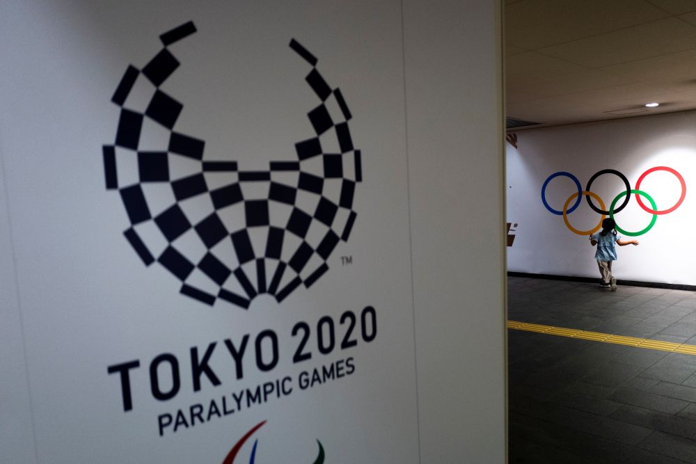 A girl runs past Olympic rings and the logo of Tokyo 2020 Paralympic Games amid the coronavirus disease pandemic in Tokyo August 16, 2021. u00e2u20acu201d Reuters pic