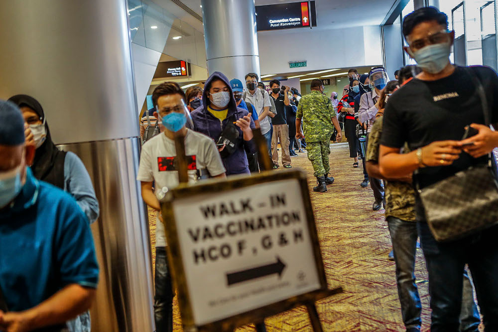 Walk-in vaccine recipients queue up for registration for their Covid-19 jabs at the Kuala Lumpur Convention Centre vaccination centre, August 2, 2021. u00e2u20acu2022 Picture by Hari Anggara