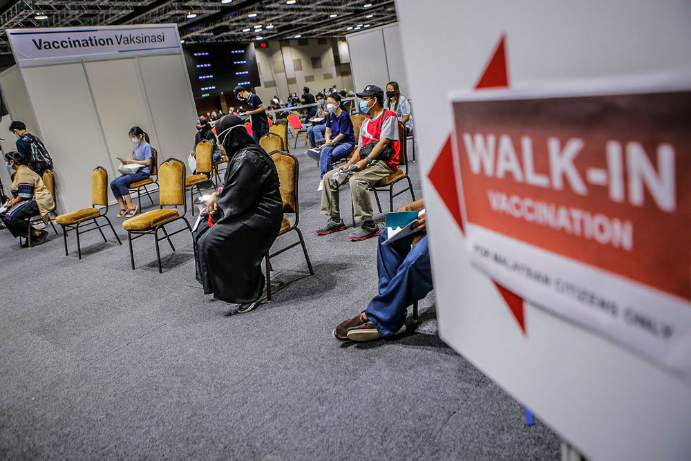 Walk-in recipients wait to get their Covid-19 vaccine injection at the Kuala Lumpur Convention Centre vaccination centre, August 2, 2021. u00e2u20acu2022 Picture by Hari Anggara