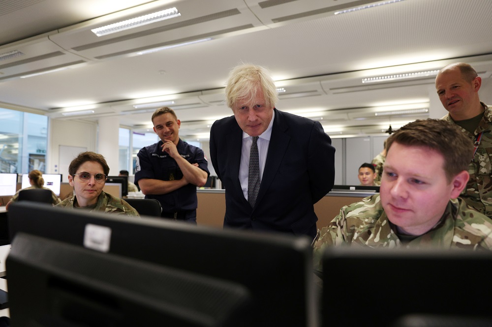 Britain's Prime Minister Boris Johnson observes the operations room for the Afghan Relocation and Assistance Policy as he visits Northwood Headquarters, the British Armed Forces Permanent Joint Headquarters, in Eastbury, northwest of London August 26, 202