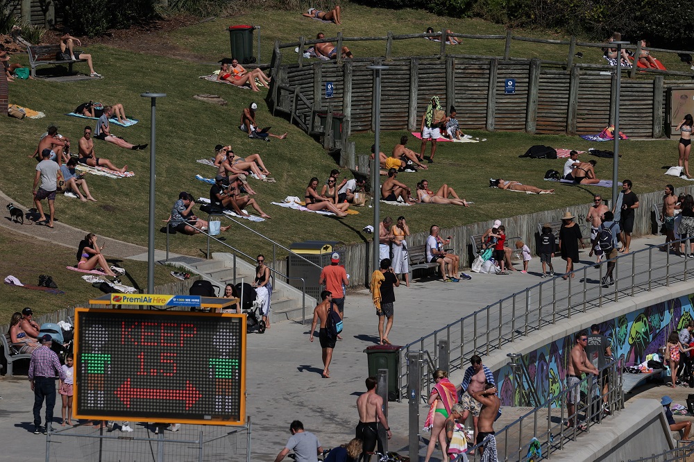 Sunbathers lie on a hill behind a social distancing sign at Bondi Beach during a lockdown to curb the spread of a coronavirus disease outbreak in Sydney September 1, 2021. u00e2u20acu201d Reuters pic