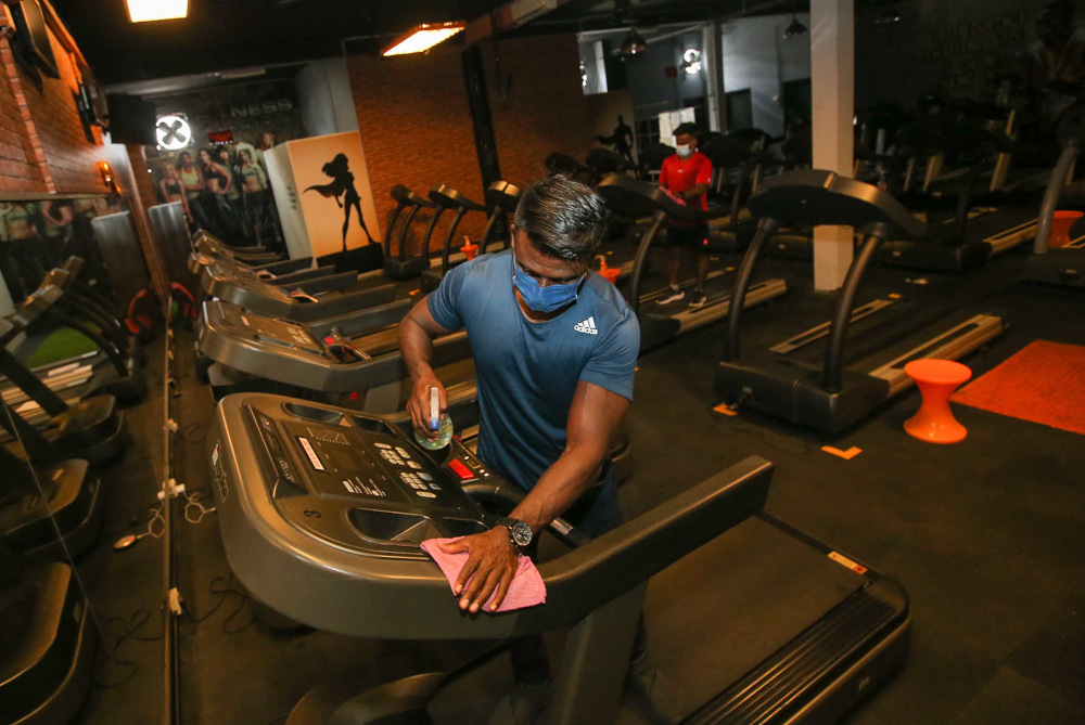 Fitness Lifestyle Gym owner V. Sam Pakiaraj cleans fitness equipment at his gym in Desa Rishah, Ipoh September 1, 2021. u00e2u20acu201d Picture by Farhan Najib