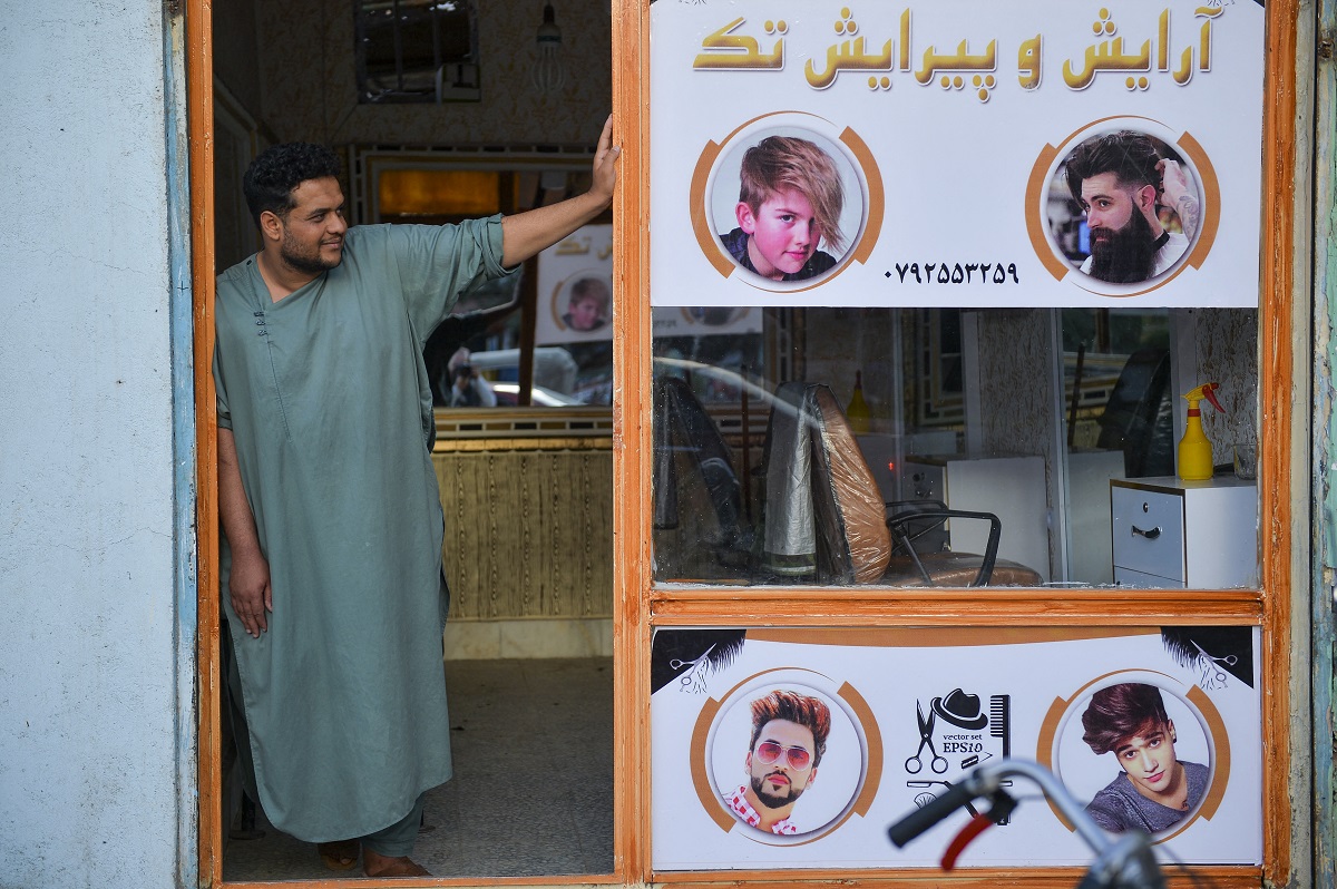 A barber waits for customers at his shop in Herat, Afghanistan, September 19, 2021 AFP