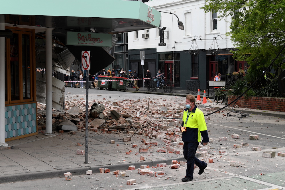 A person walks past damage to the exterior of a restaurant following an earthquake in the Windsor suburb of Melbourne September 22, 2021. u00e2u20acu201d AAP Image/James Ross via Reuters