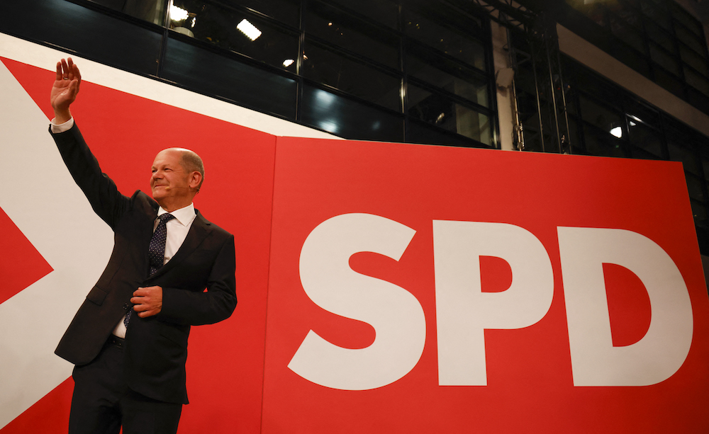 German Finance Minister, Vice-Chancellor and the Social Democrats (SPD) candidate for Chancellor Olaf Scholz waves after the estimates were broadcast on TV in Berlin September 26, 2021. u00e2u20acu201d AFP pic