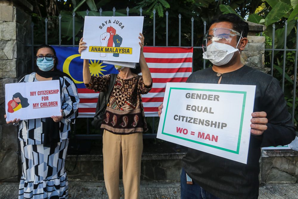 Members of Family Frontiers hold up placards demanding equal citizenship rights for Malaysians outside the Parliament building in Kuala Lumpur September 23, 2021. u00e2u20acu201d Picture by Yusof Mat Isa