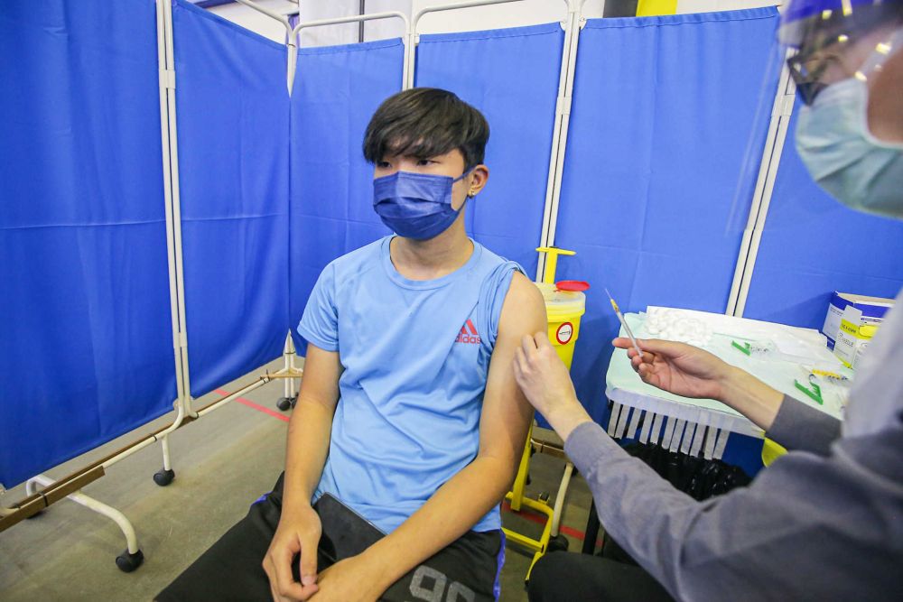 A student receives his Covid-19 jab at the Kinta Town Hall in Batu Gajah September 21, 2021. u00e2u20acu201d Picture by Farhan Najib