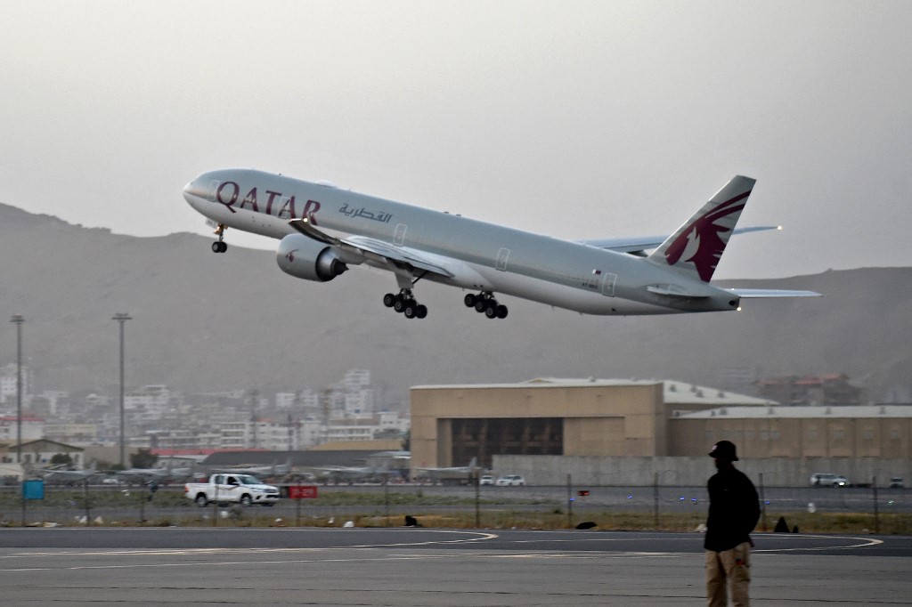 A Qatari security personnel stands guard as a Qatar Airways aircraft takes off from the airport in Kabul on September 9, 2021. Some 200 passengers left Kabul airport on the first flight carrying foreigners out of the Afghan capital. u00e2u20acu201d AFP pic