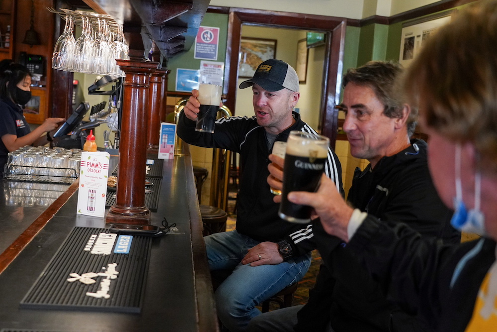 Customers Brian O'Mara, Darrell Forman and Doug Thomas drink beers together at the Fortune of War pub, on the first morning of pubs and many other businesses re-opening to vaccinated people in Sydney October 11, 2021. u00e2u20acu201d Reuters pic