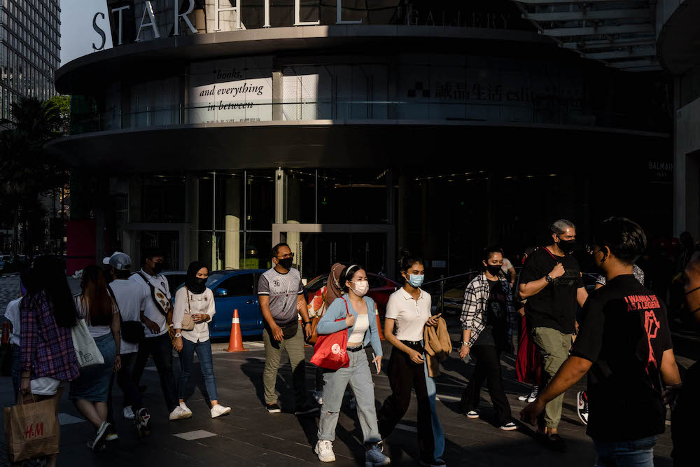 People are seen wearing protective masks as they walk along the Bukit Bintang shopping area in Kuala Lumpur on October 9, 2021. u00e2u20acu201d Picture by Firdaus Latif