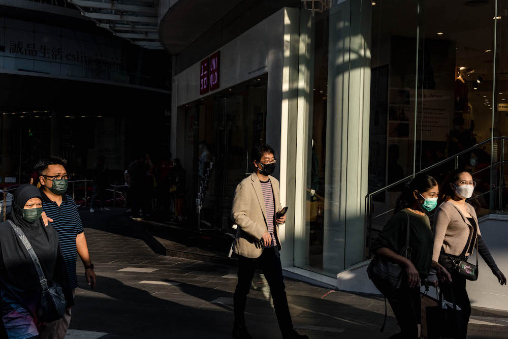 People are seen wearing protective masks as they walk along the Bukit Bintang shopping area in Kuala Lumpur on October 9, 2021. u00e2u20acu201d Picture by Firdaus Latif