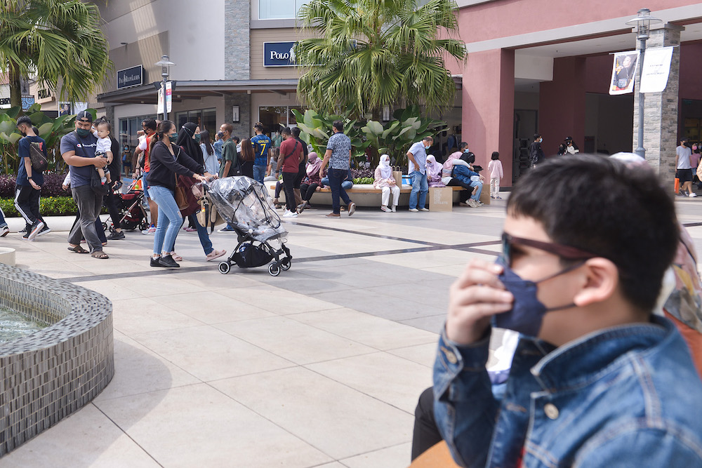 People spend time shopping with their families at Genting Premium Outlet shopping mall in Genting Highland during the first weekend of interstate travel restriction lifted on October 16, 2021. u00e2u20acu201d Picture by Miera Zulyana