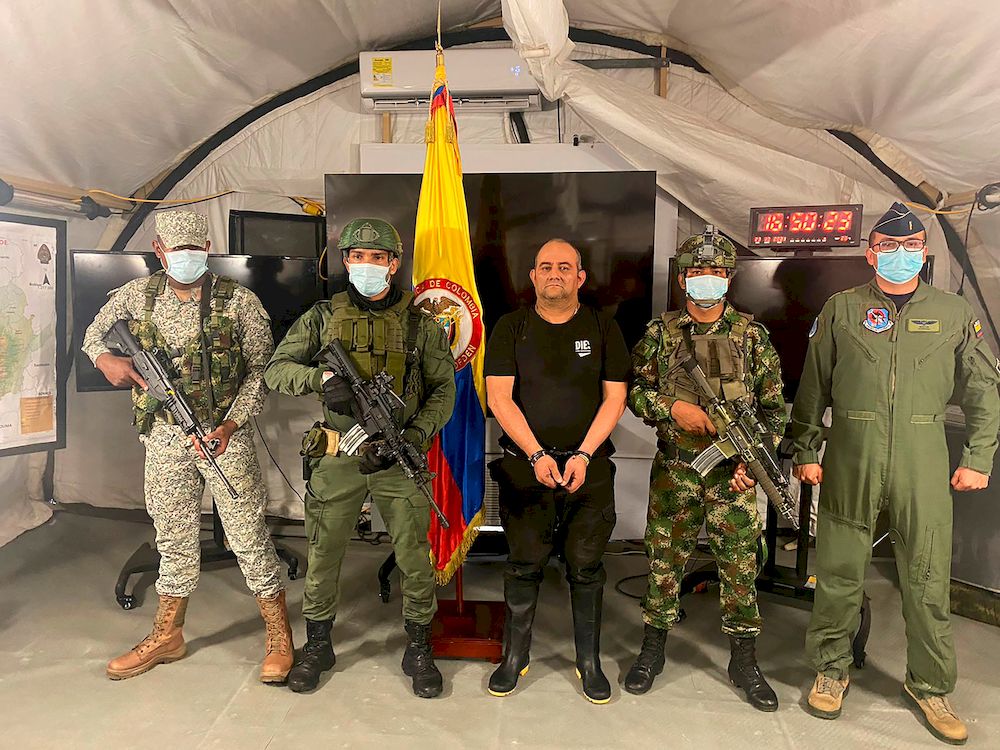 Dairo Antonio Usuga David, alias u00e2u20acu02dcOtonielu00e2u20acu2122, top leader of the Gulf clan, poses for a photo escorted by Colombian military soldiers after being captured, in Necocli, Colombia October 23, 2021. u00e2u20acu201d Reuters pic