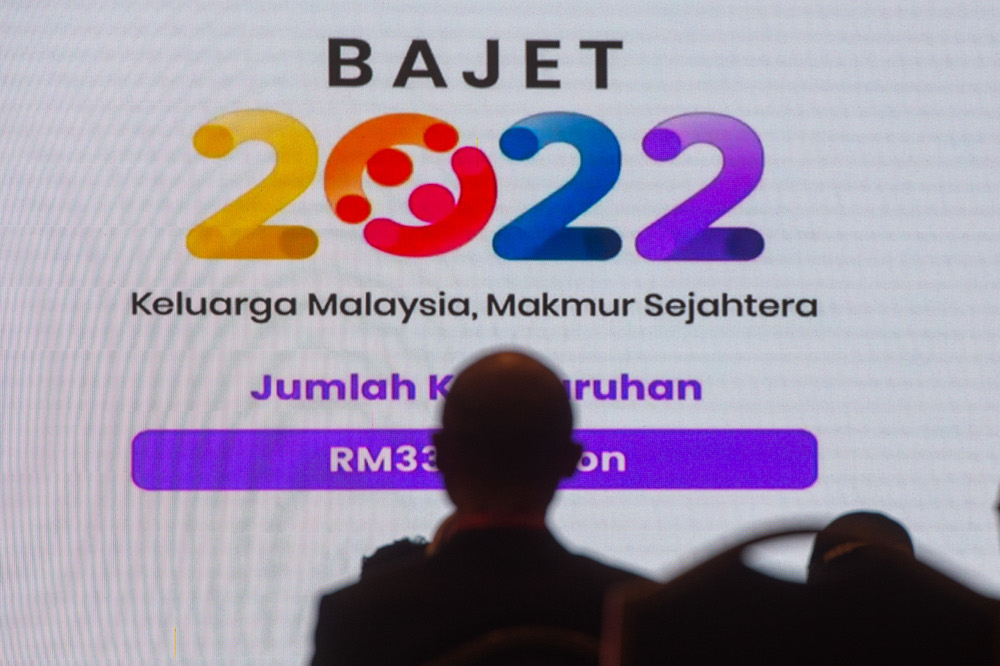 Government servants watch Finance Minister Datuk Seri Tengku Zafrul Abdul Aziz speaking during the tabling of Budget 2022 in the Dewan Rakyat, October 29, 2021. u00e2u20acu201d Picture by Shafwan Zaidon
